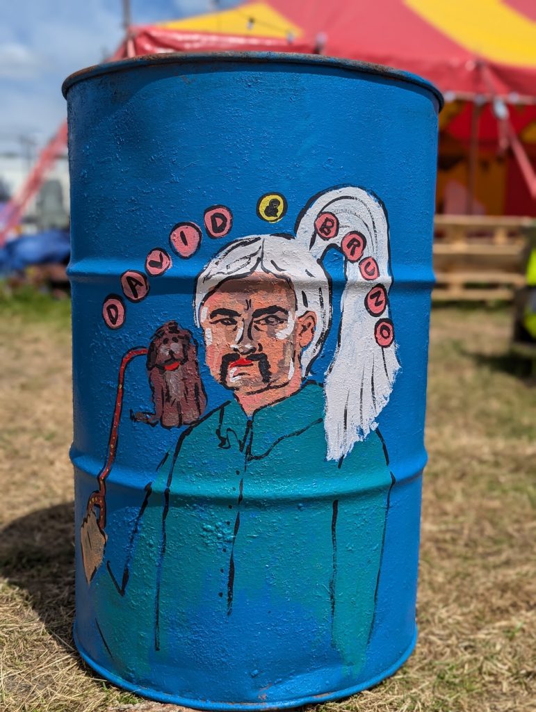 glastonbury charity bins 2024 david and bruno white haired man and cockapoo